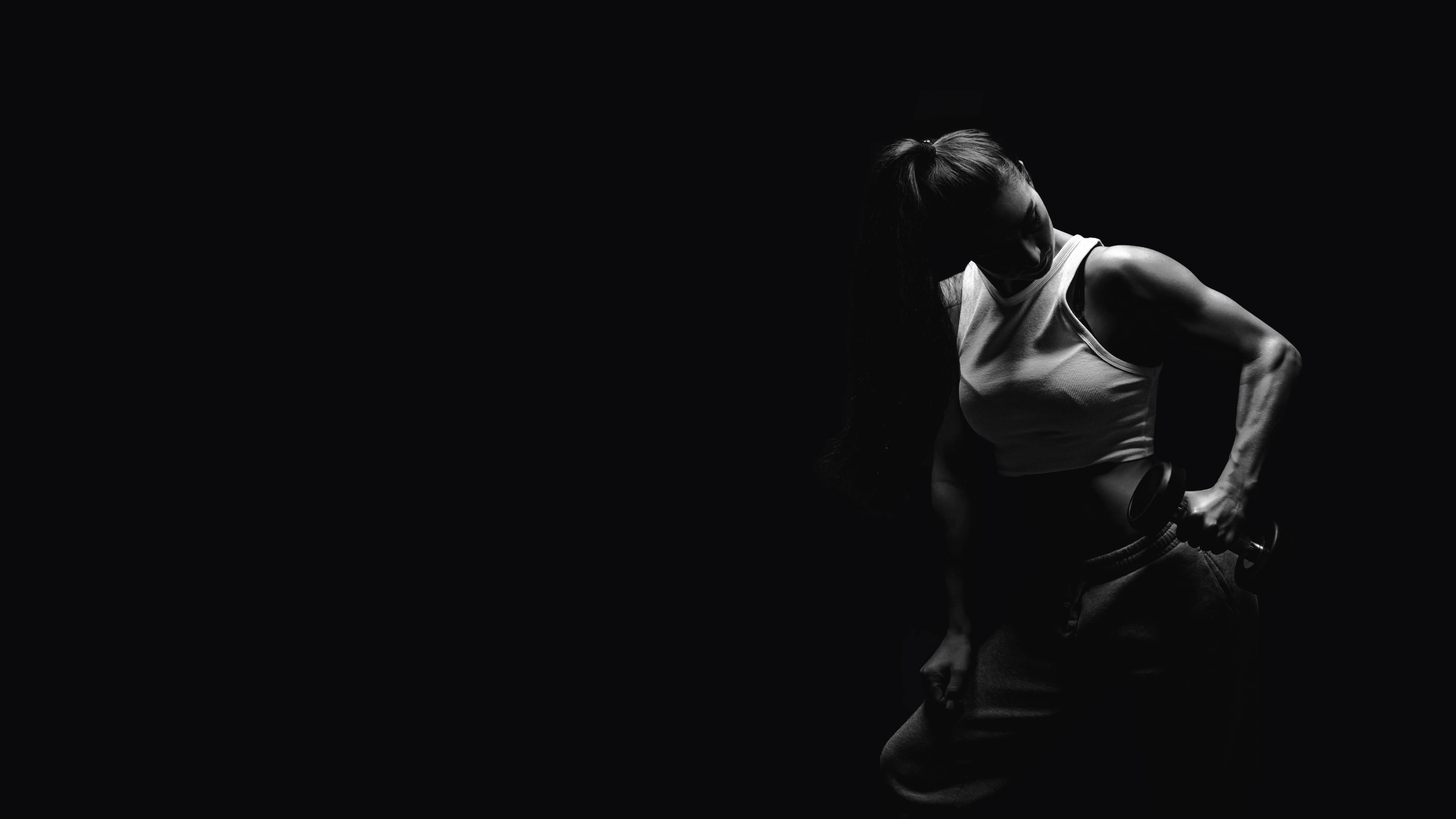 Person sitting in a dark room with minimal light